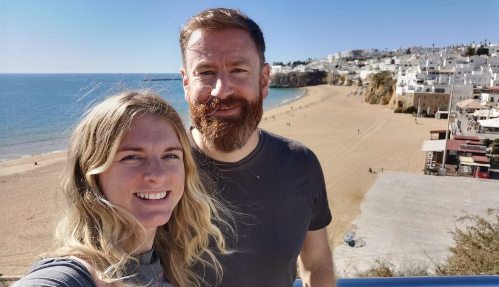 A couple smiling together overlooking Albufeira beach
