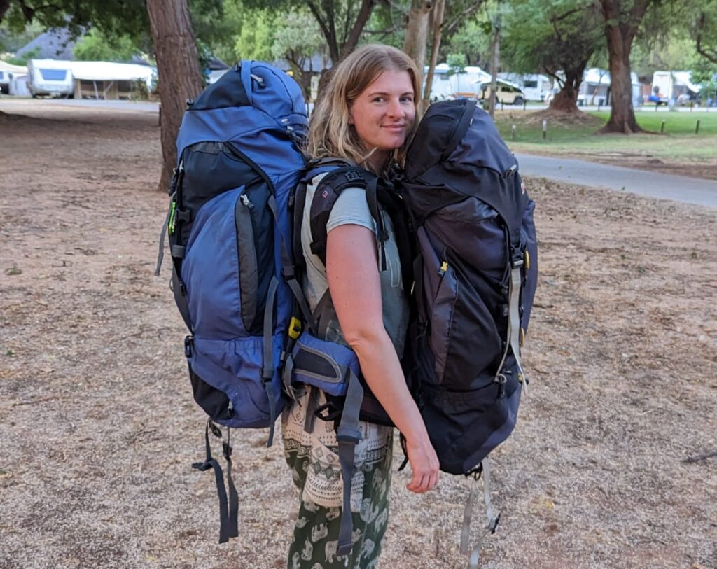 Woman carrying 2 backpacks