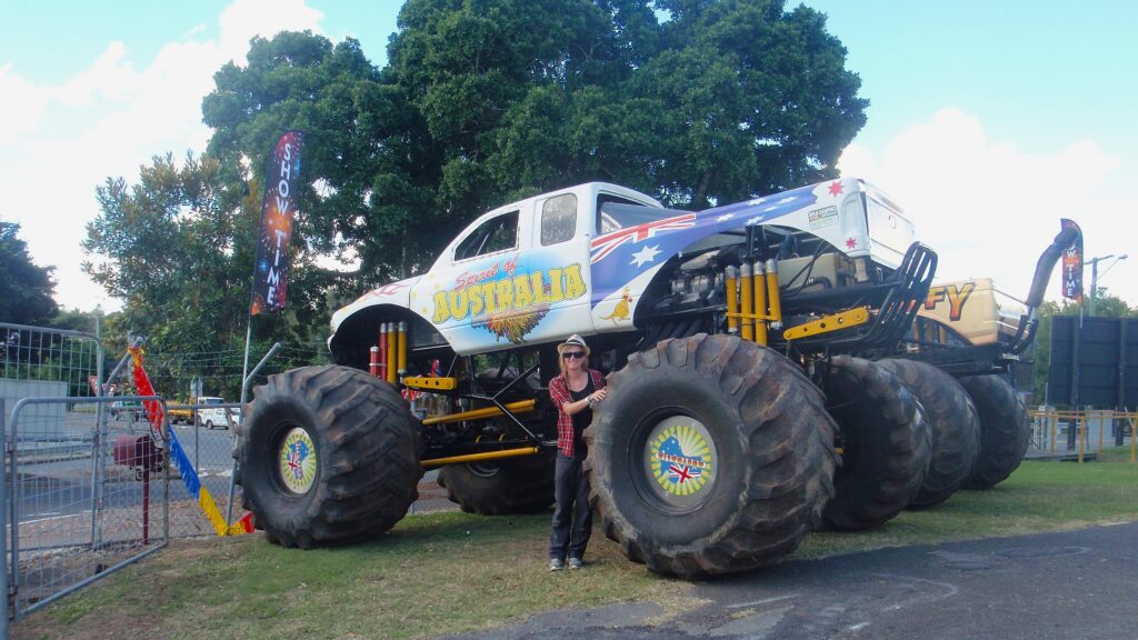 Woman stood in front of a monster truck
