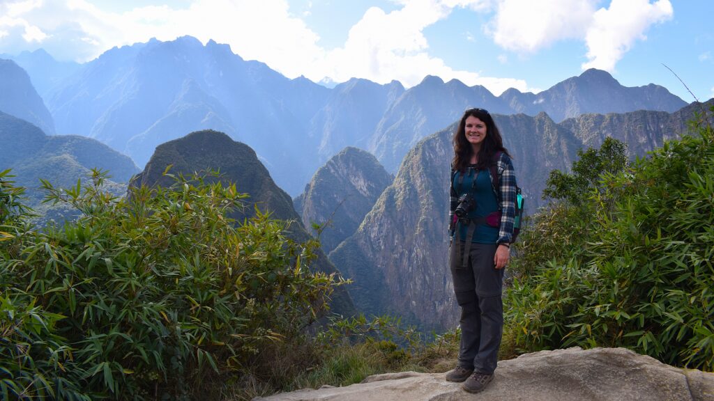 A woman in hiking gear in the mountains of Peru