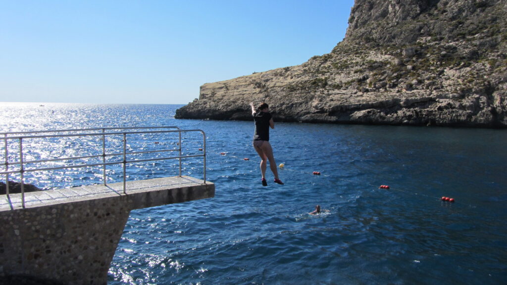 Woman jumping into the sea
