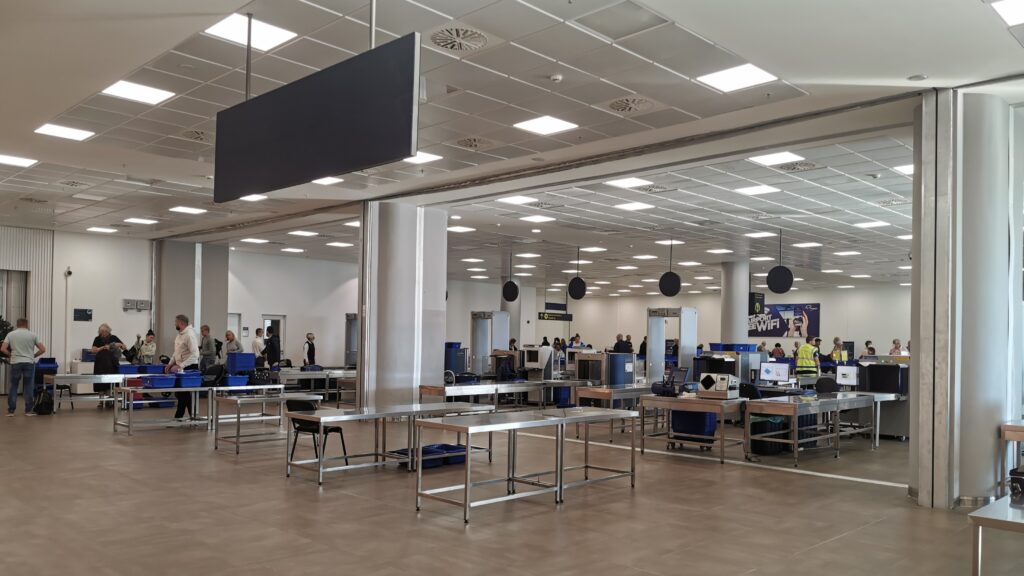 The security area at an airport with metal detectors and x-ray machines