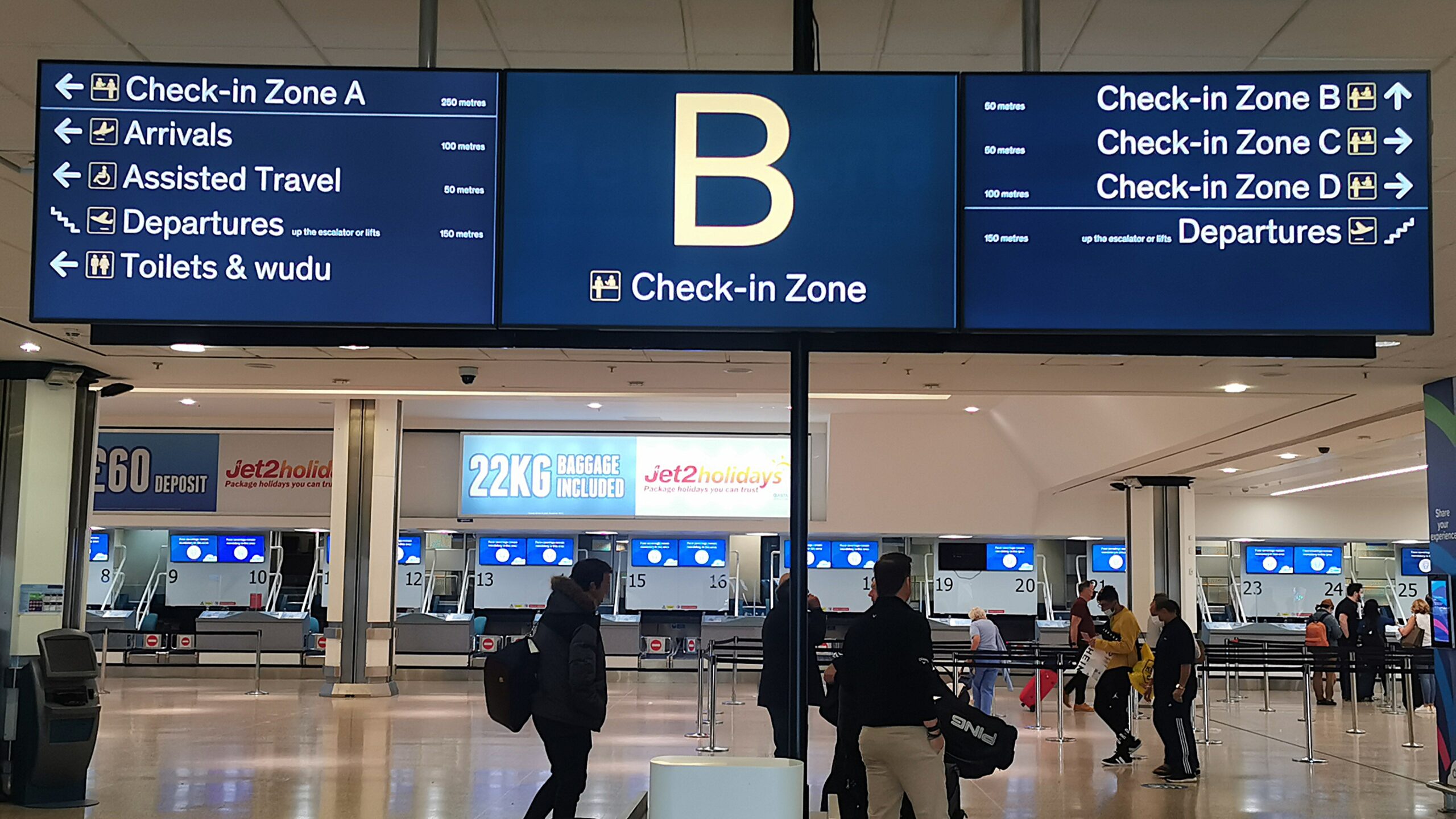 Sign showing directions to various check-in areas at an airport