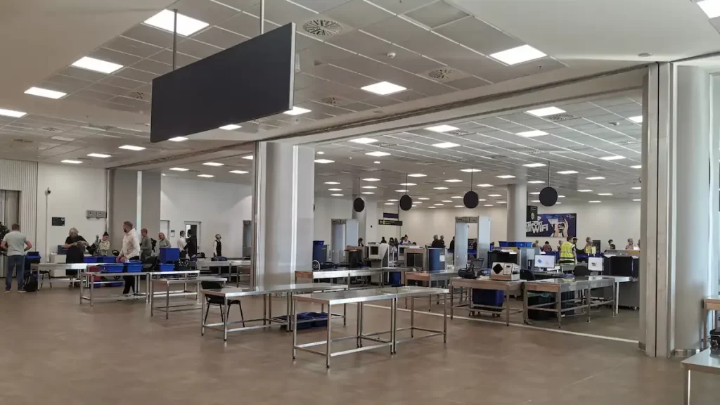 The security area at an airport with metal detectors and x-ray machines