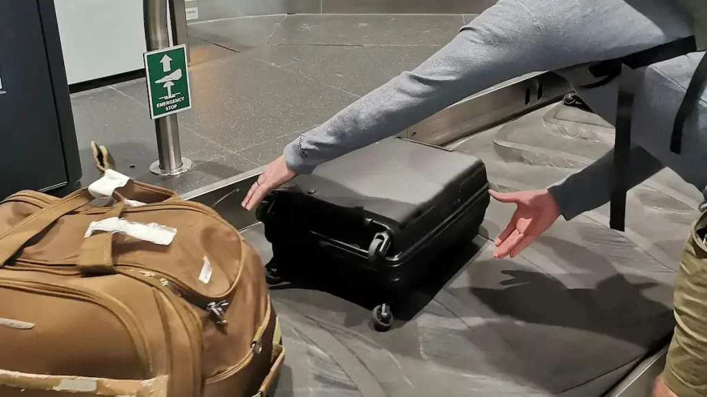 Collecting a bag from a baggage carousel at the airport