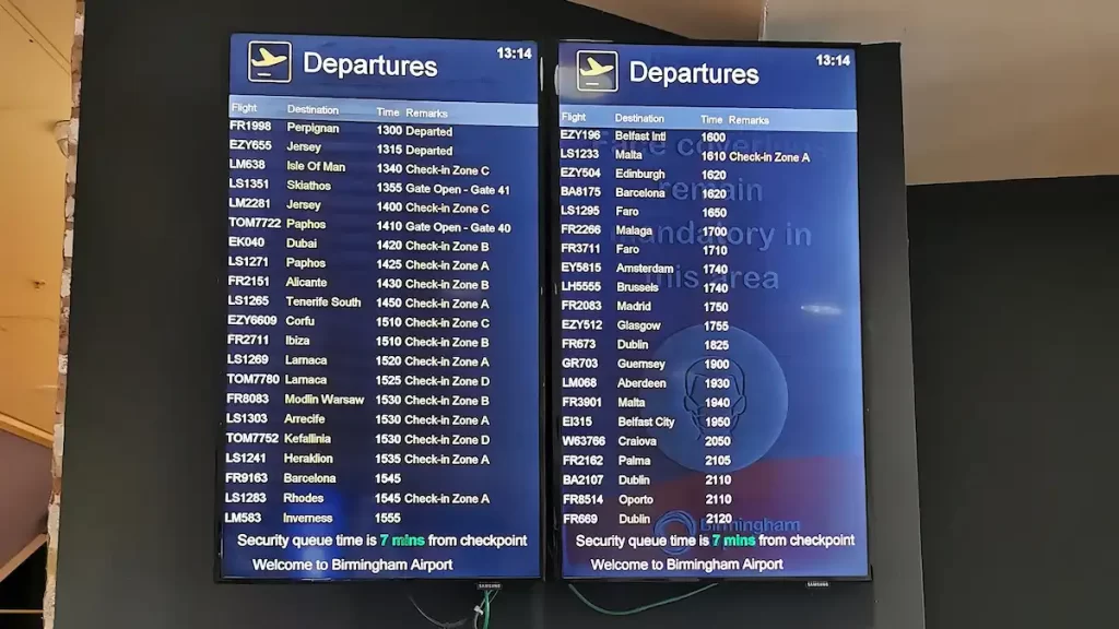 TV screen showing check-in zone locations at an airport