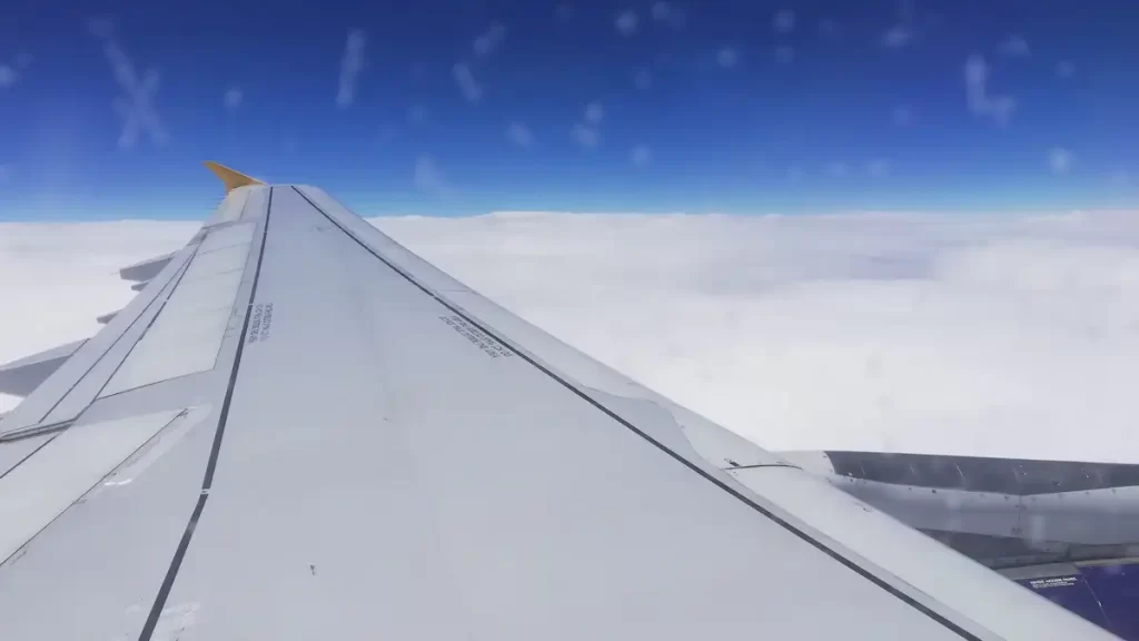 View from a plane window looking over clouds