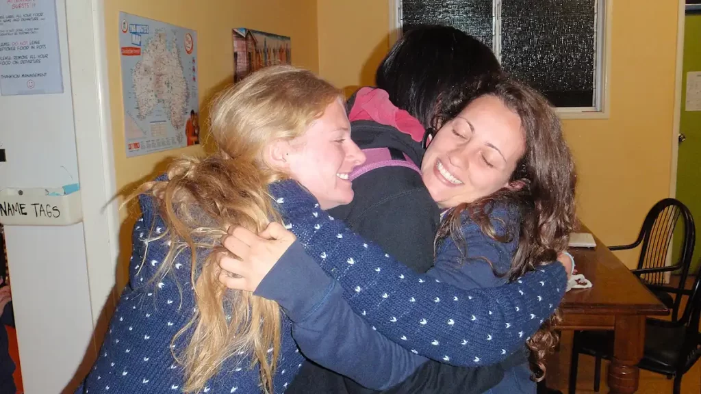 Three young women hugging