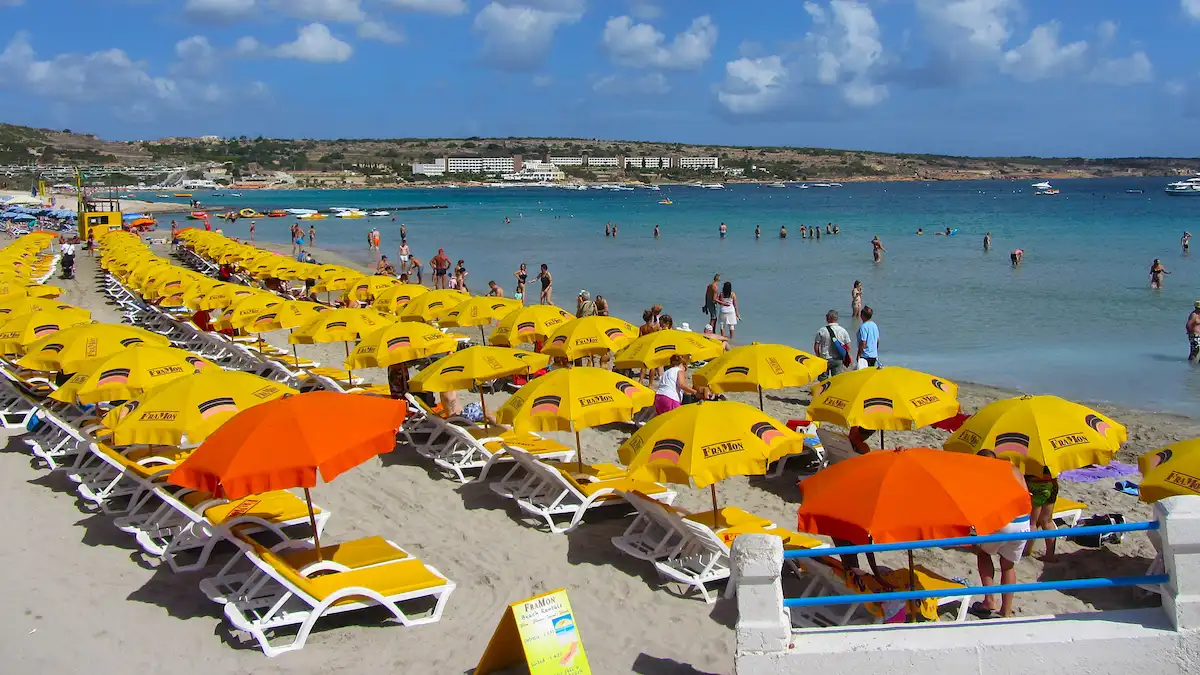 Beach in Malta with loungers and umbrellas