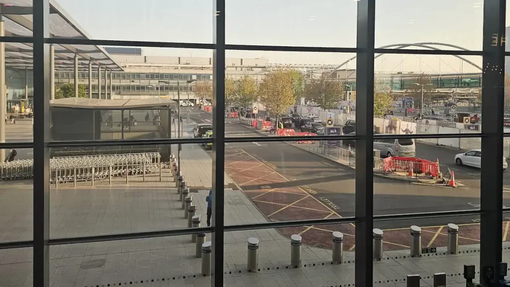 Looking through a window to the entrance of an airport