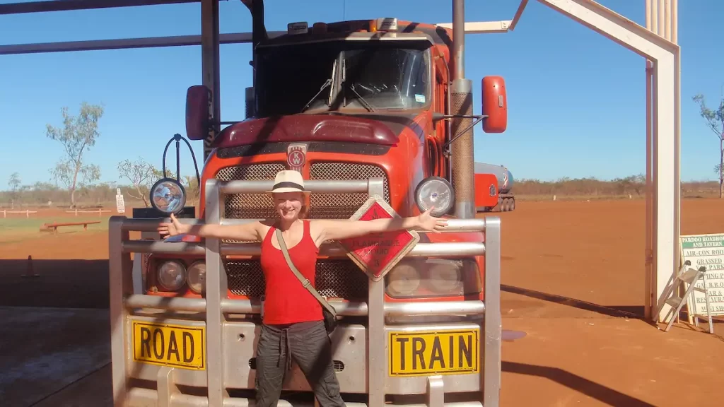 Woman stood in front of a road train