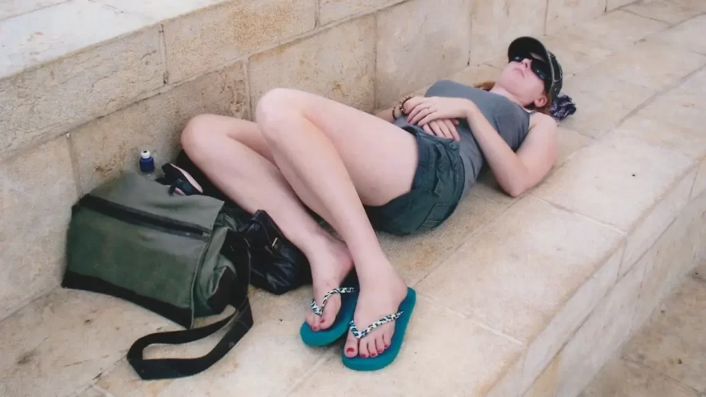 Woman sleeping on concrete steps