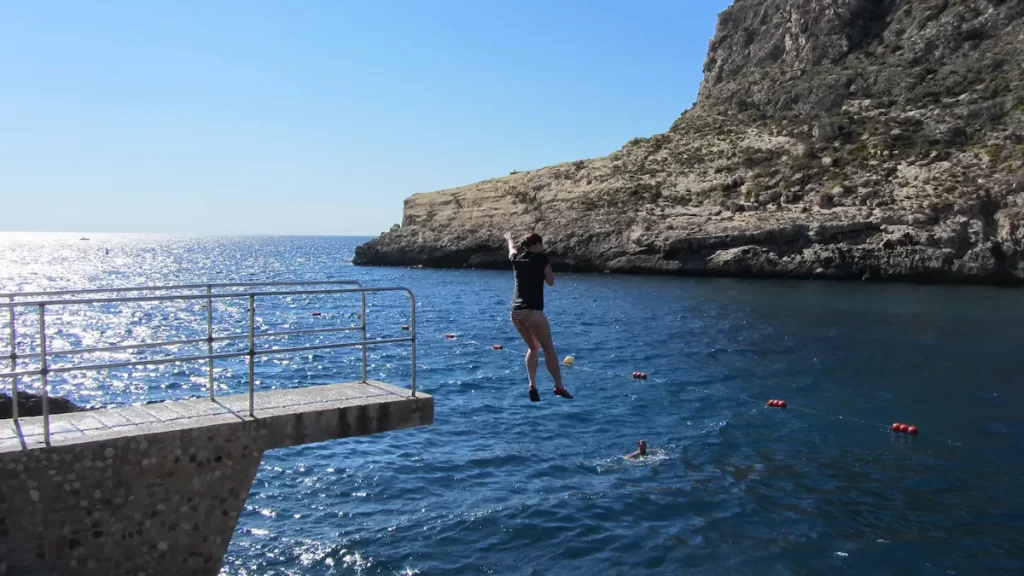 Woman jumping into the sea