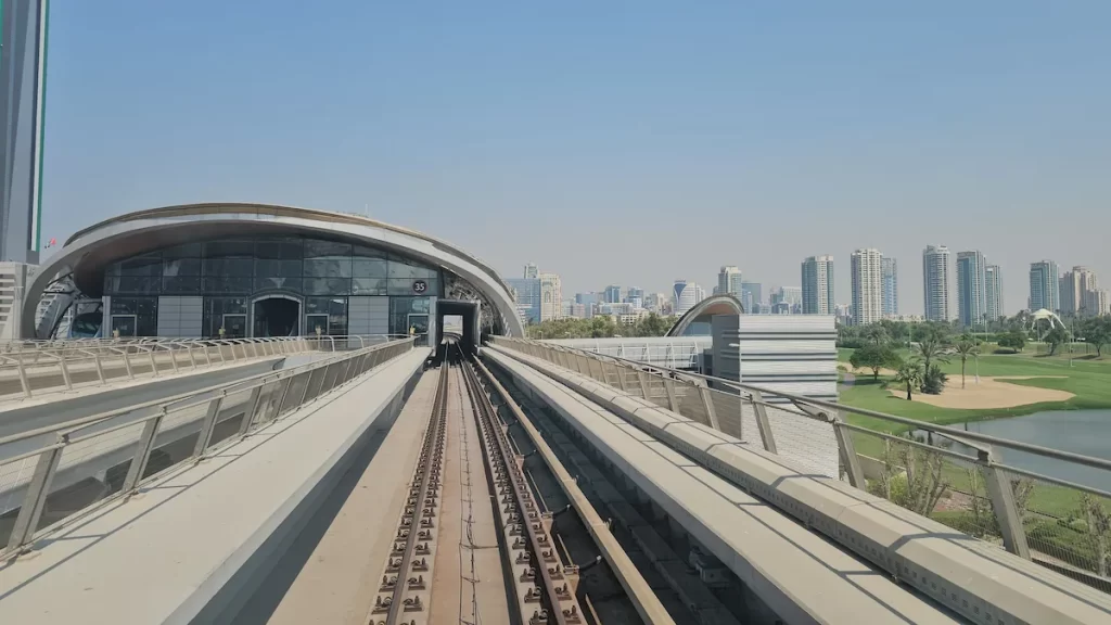First person view of the Dubai monorail tracks on a sunny day with skyscrapers in the background