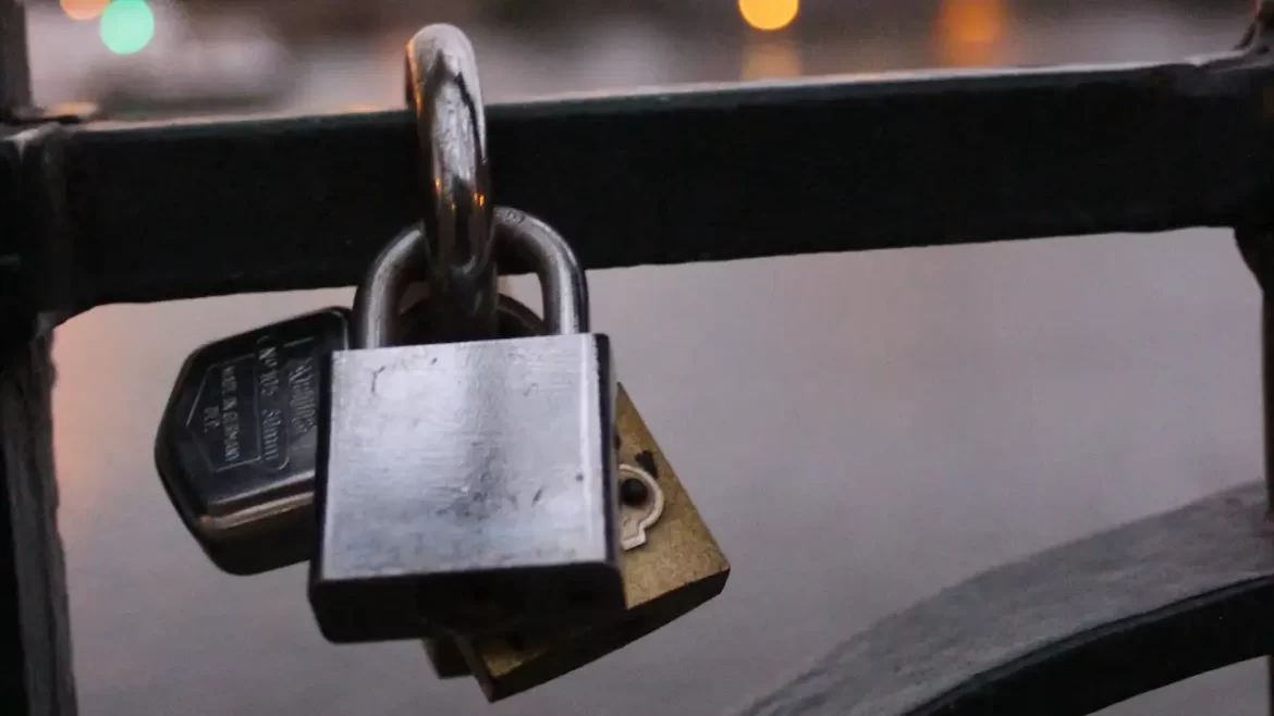 Close up of several padlocks attached to a bridge