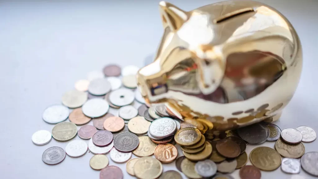 Gold piggy bank surrounded by coins