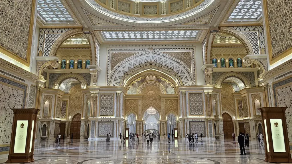A large opulent hall in the Grand Palace in Abu Dhabi. The floor and wall is made of white marble and its ornately decorated with gold leaf