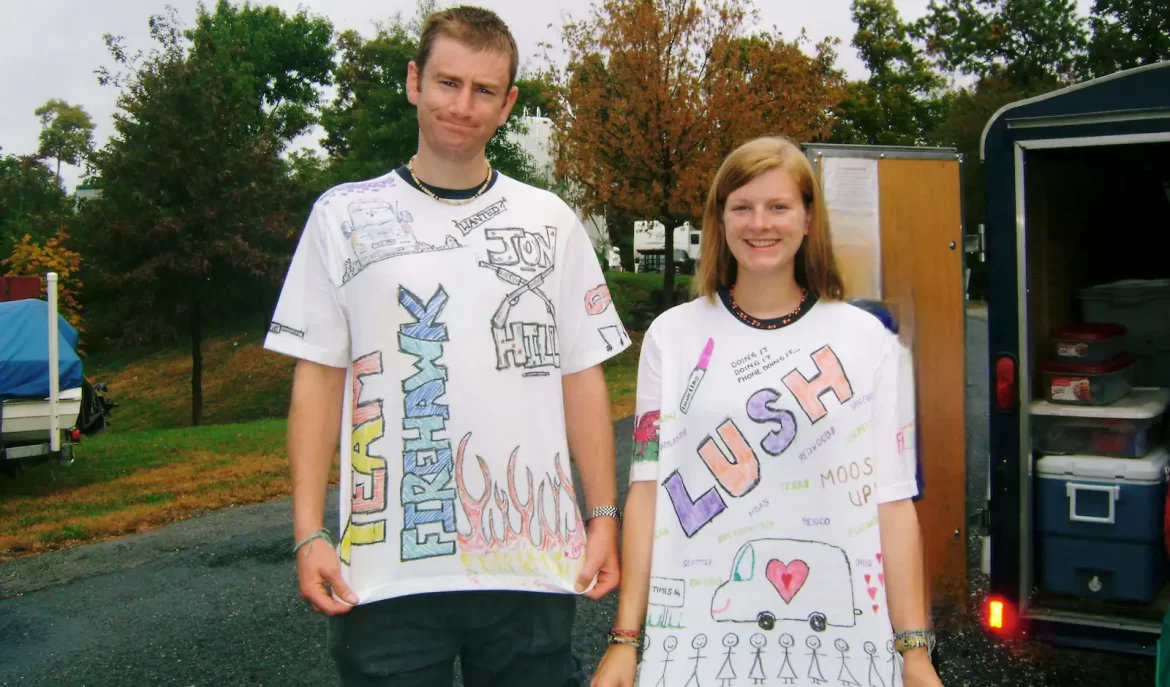 Young couple wearing white T-shirts which have lots of hand drawn pictures and words on them