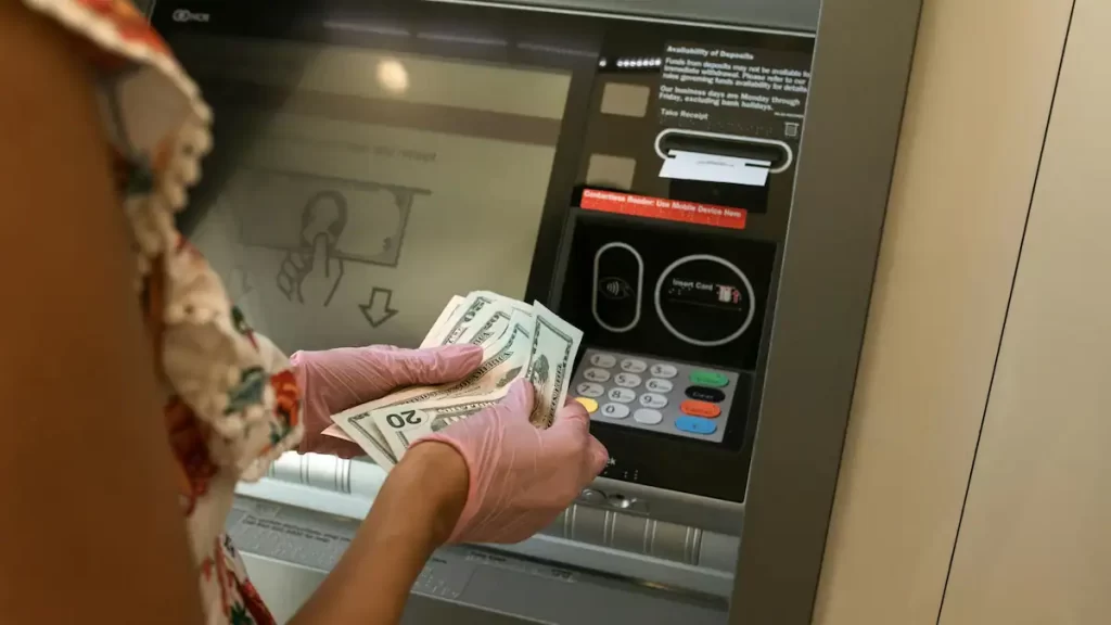 Female hands counting cash just withdrawn from an ATM