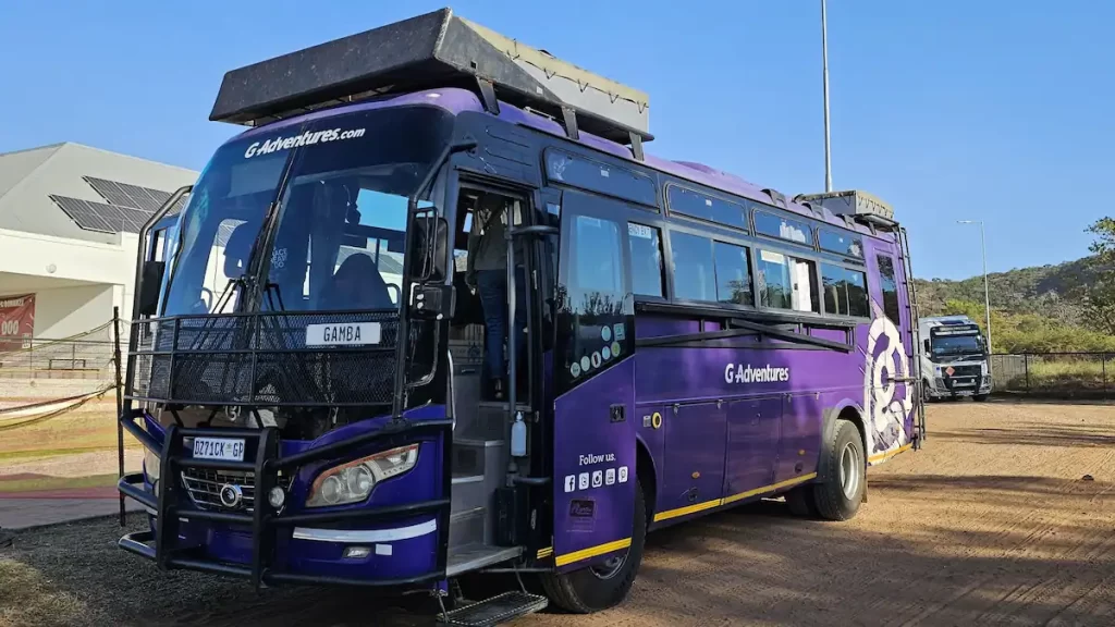 A purple bus with a log for G Adventures
